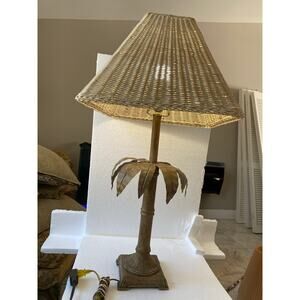 palm tree table lamp featuring a faux bamboo stalk and a woven rattan shade